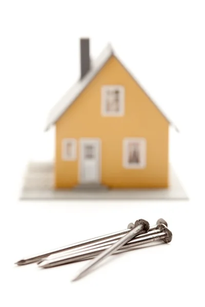 House and Nails Isolated on White — Stock Photo, Image