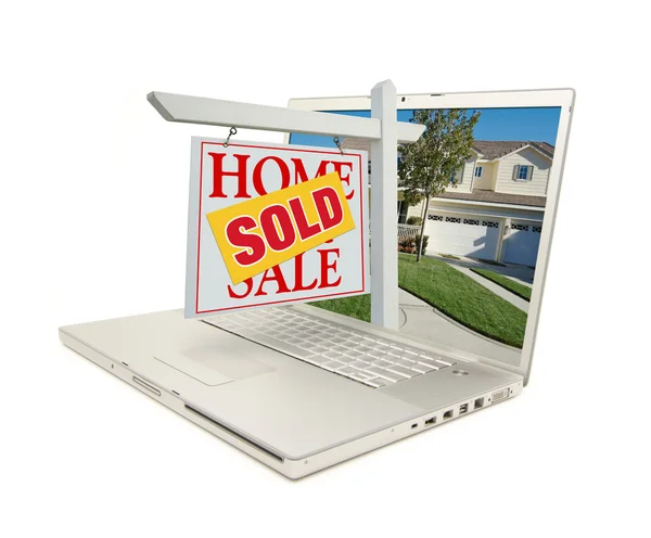 Kırmızı ev satışı işareti laptop için sattı. — Stok fotoğraf