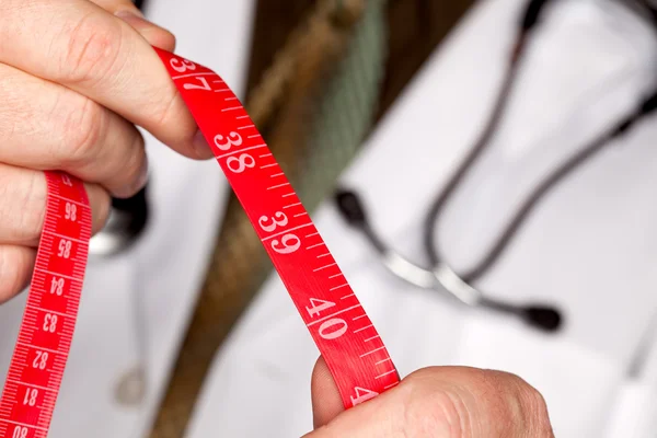 Médico con cinta métrica de estetoscopio — Foto de Stock