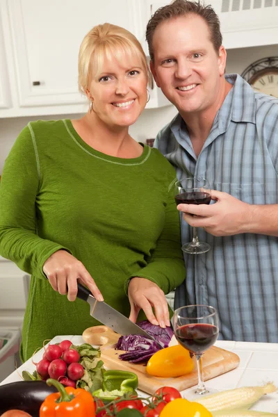 Couple Drinking Wine in the Kitchen Stock Image