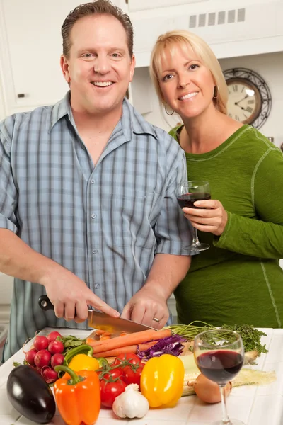 Happy Couple Preparing Food in Kitchen Stock Photo