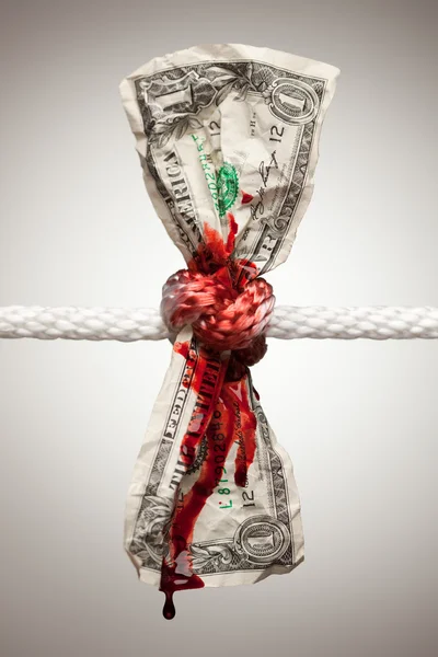 Wrinkled Dollar Tied Up and Bleeding Royalty Free Stock Images