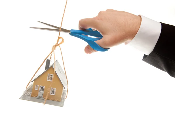 Hand, Scissors Cutting String with House — Stock Photo, Image