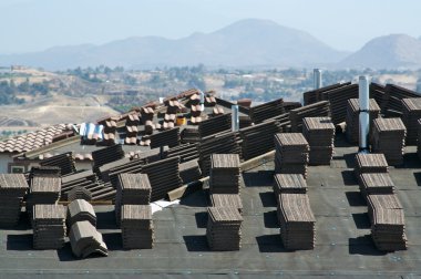 New Home Construction Site Roof with Stacks of Tiles clipart