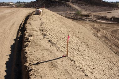 Sandbags, Marker Sticks at Dirt Lot clipart