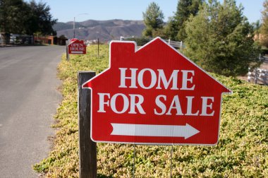 Home For Sale Signs Along Side Street clipart