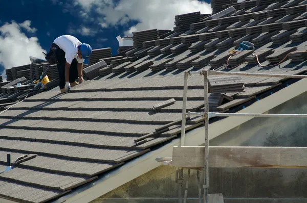 盖屋顶的人铺设瓷砖 — 图库照片