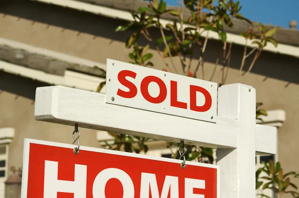 Sold Home For Sale Sign and New House — Stock Photo, Image