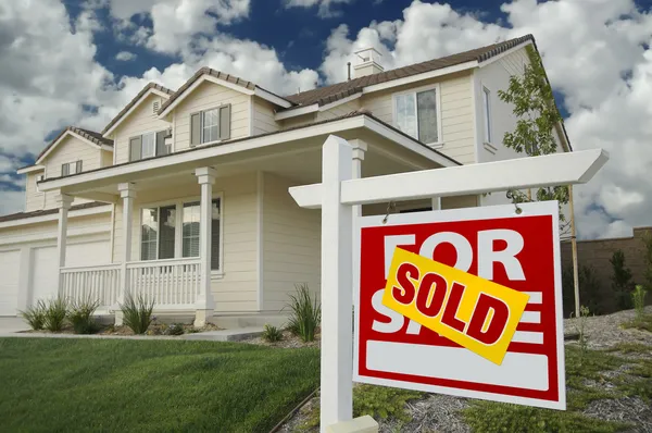 Sold Home For Sale Sign and New House — Stockfoto