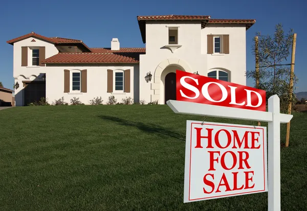 Sold Home For Sale Sign and New House — Stock Photo, Image
