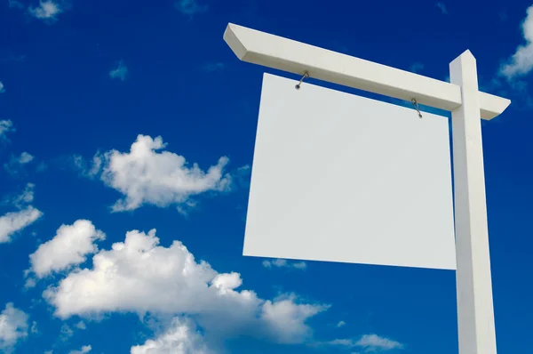 Blank Real Estate Sign OVer Clouds Stock Image