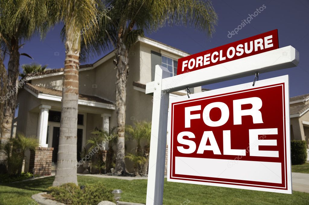 Red Foreclosure Sign in Front of House