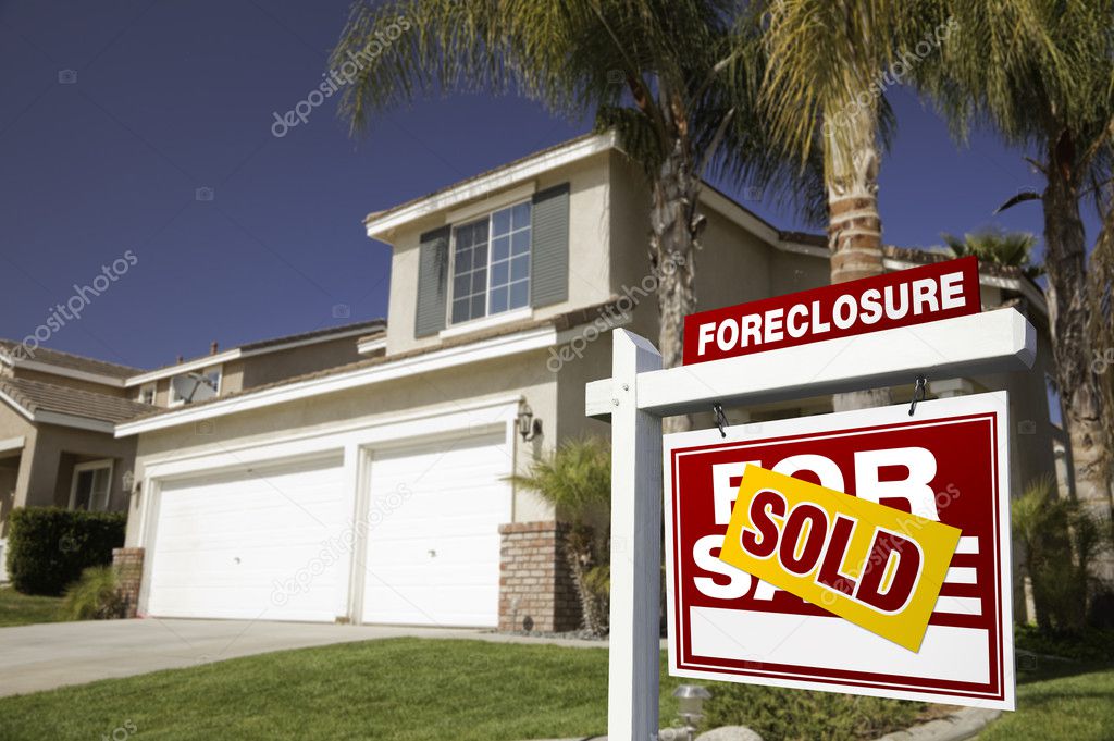 Red Sold Foreclosure Sign and House