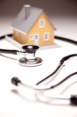 Stethoscope and Model House clipart