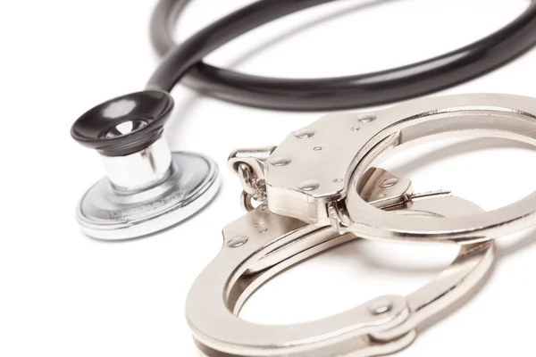 Stethoscope and Handcuffs Isolated — Stock Photo, Image