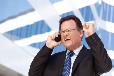 Excited Businessman Using Cell Phone clipart