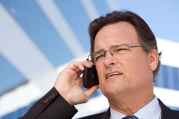 Улыбающийся бизнесмен разговаривает по телефону — стоковое фото