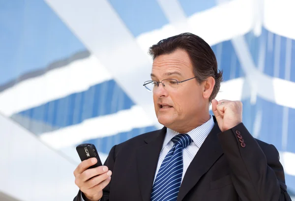 Empresario excitado usando teléfono celular — Foto de Stock