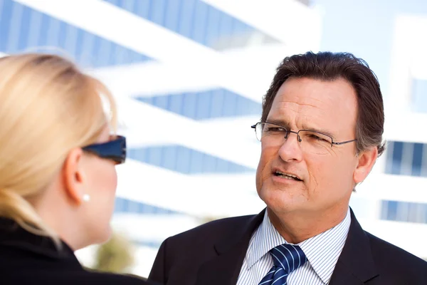 Businessman and Woman Talking Outside Stock Photo