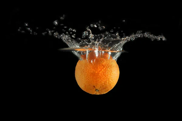 stock image Tangerine falling into water