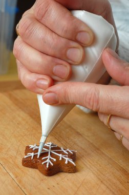 Woman hand decorating Christmas sweets clipart