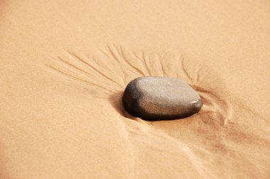 Stone in sand clipart