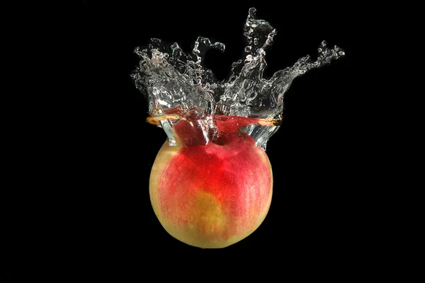 Stock image Red apple falling into water