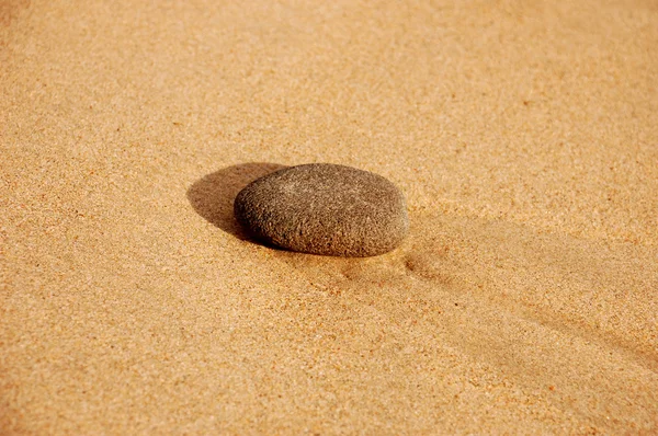 Stone in sand — Stock Photo, Image