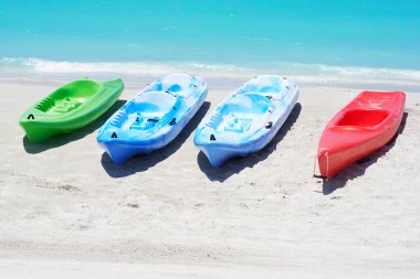 Group of kayaks in a beach clipart