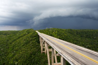 Tall bridge in a stormy weather clipart