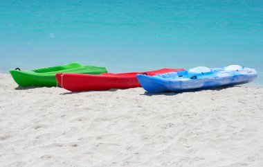 Group of kayaks in a beach clipart