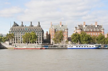 Ancient houses across the river Thames in London clipart