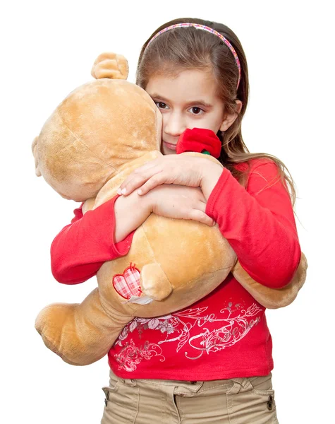 Liten flicka kramar en nallebjörn — Stockfoto