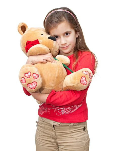 Маленькая девочка обнимает плюшевого мишку — стоковое фото