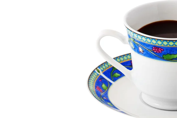 Uma xícara de café em um prato colorido — Fotografia de Stock