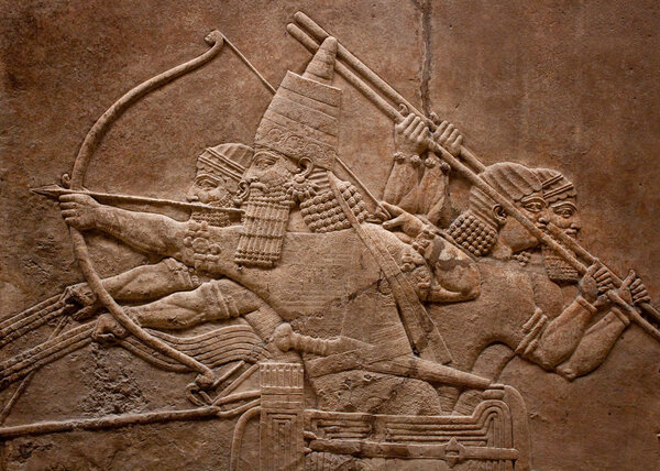 Ancient relief of assyrian fighting