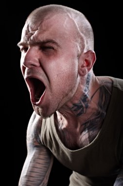 Angry tattooed man screaming clipart