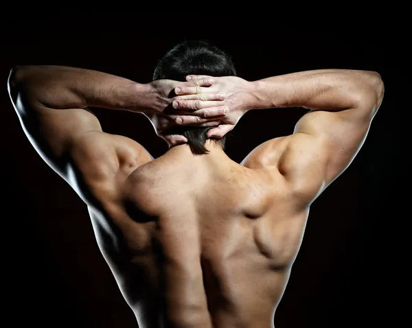 Costas de homem jovem muscular — Fotografia de Stock