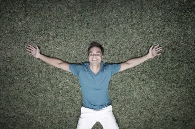 Man laying on the grass clipart