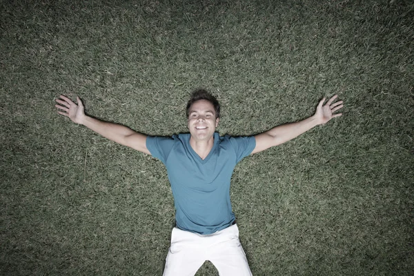 Man laying on the grass — Stock Photo, Image