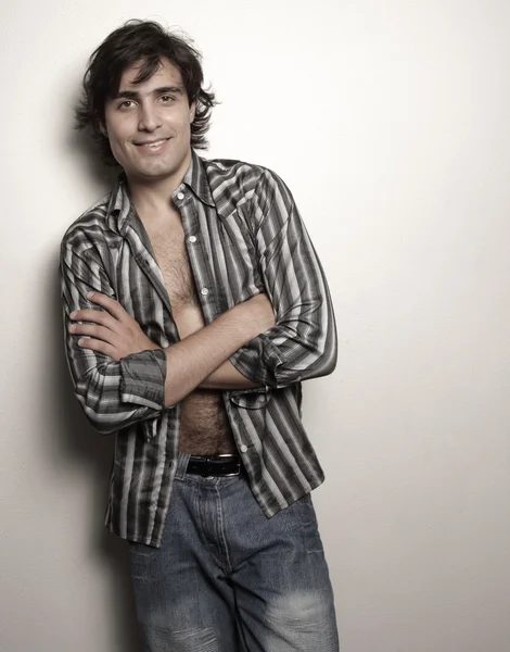Man with shirt unbuttoned and arms crossed — Stock Photo, Image