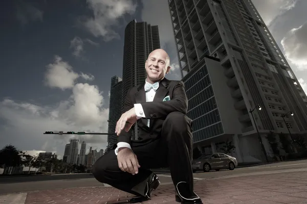 Unusual perspective of a man in a tux in the city — Stock Photo, Image