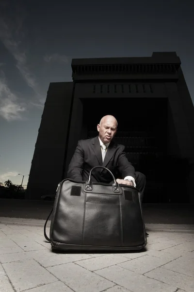 Businessman going through his briefcase at night — Stock Photo, Image