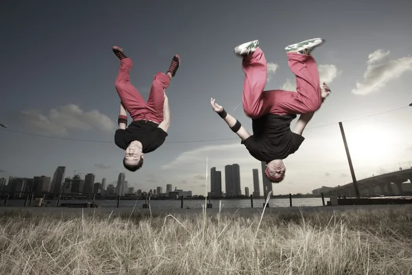 Image of two men performing a midair flip — Stock Photo, Image