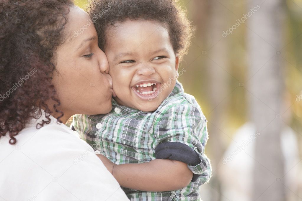 Young mother with her smiling toddler in her arms