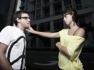 Woman quieting her boyfriend clipart