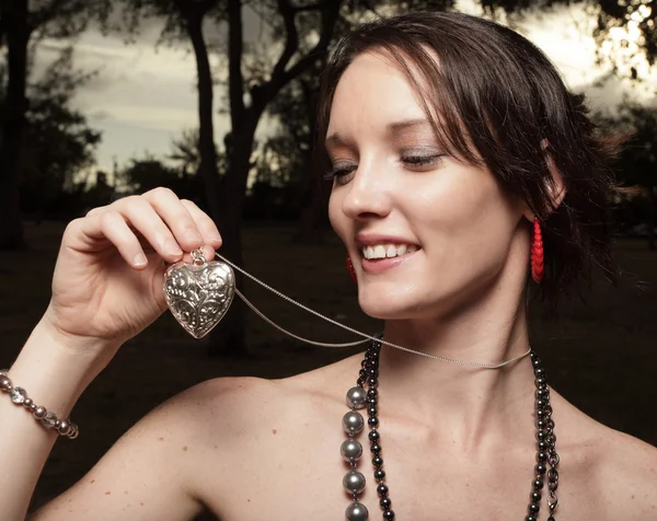 Woman holding her heart necklace — Stock Photo, Image