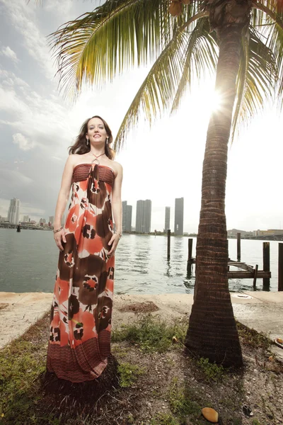 Modieuze vrouw door een palmboom — Stockfoto