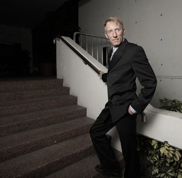 Businessman by the staircase — Stock Photo, Image
