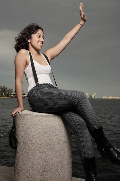 Woman sitting and waving — Stock Photo, Image